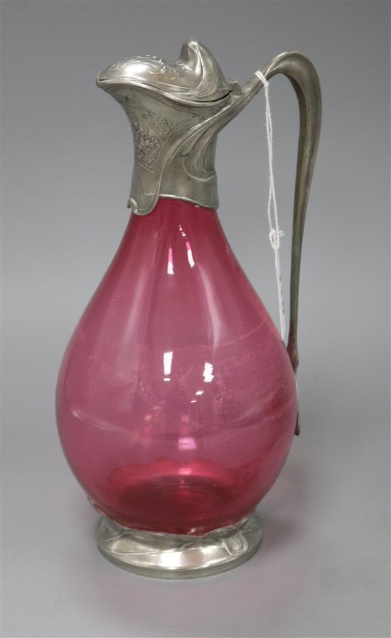 A pewter mounted cranberry claret jug Height 26cm